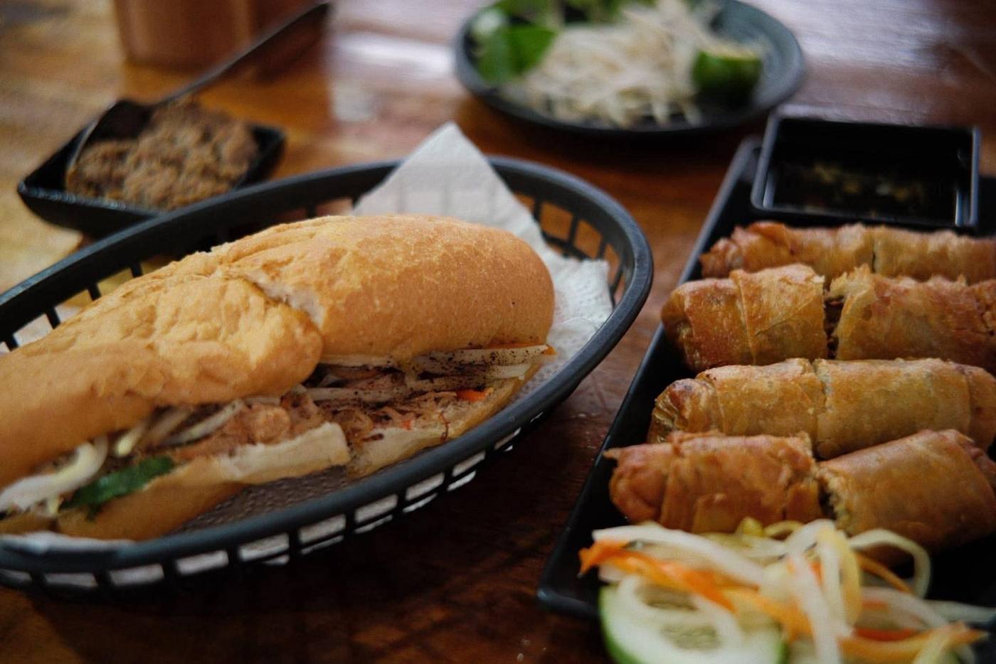 Bánh mì and fried spring rolls on the table
